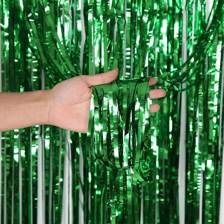 “Shiny green fringe curtain backdrop”