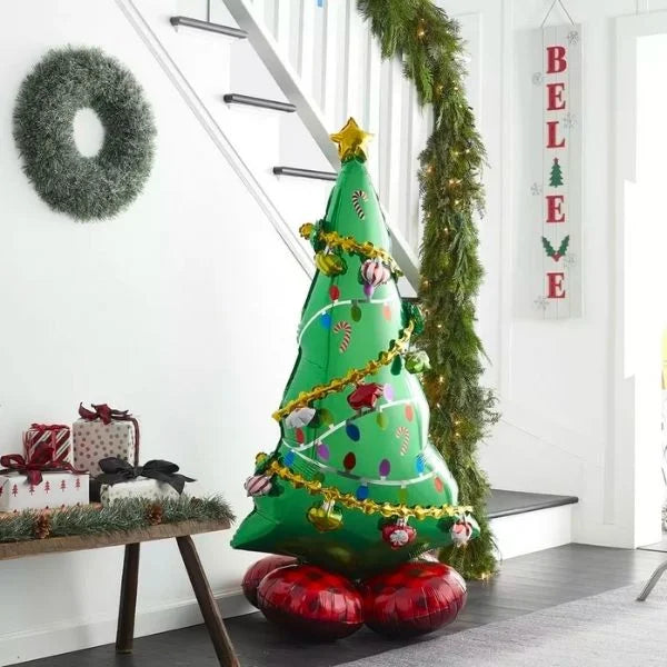"Standing foil Christmas tree balloon in holiday home decor setup"