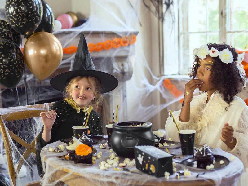 “Kids around Halloween table with white flower crown”