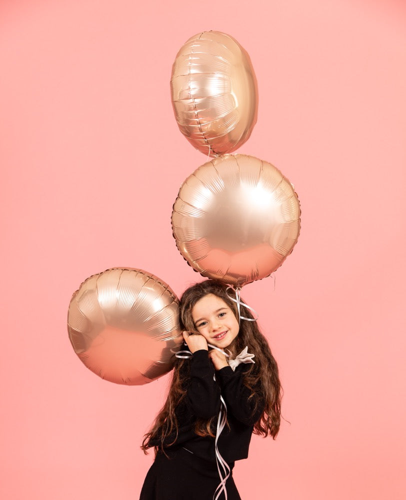 “Girl holding Californian Gold Grabo balloons – elegant party decor”
