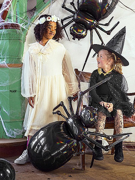 “Children in costume wearing flower crowns at celebration”