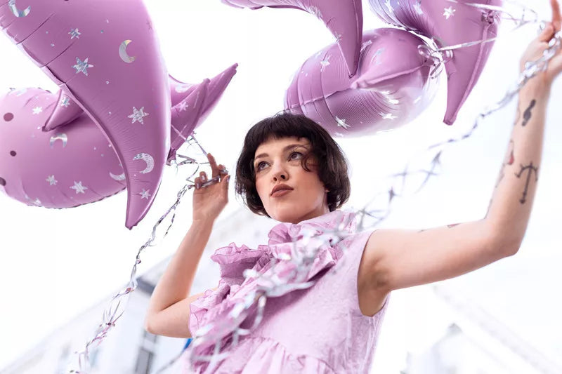 "Girl holding pink holographic ghost balloon"