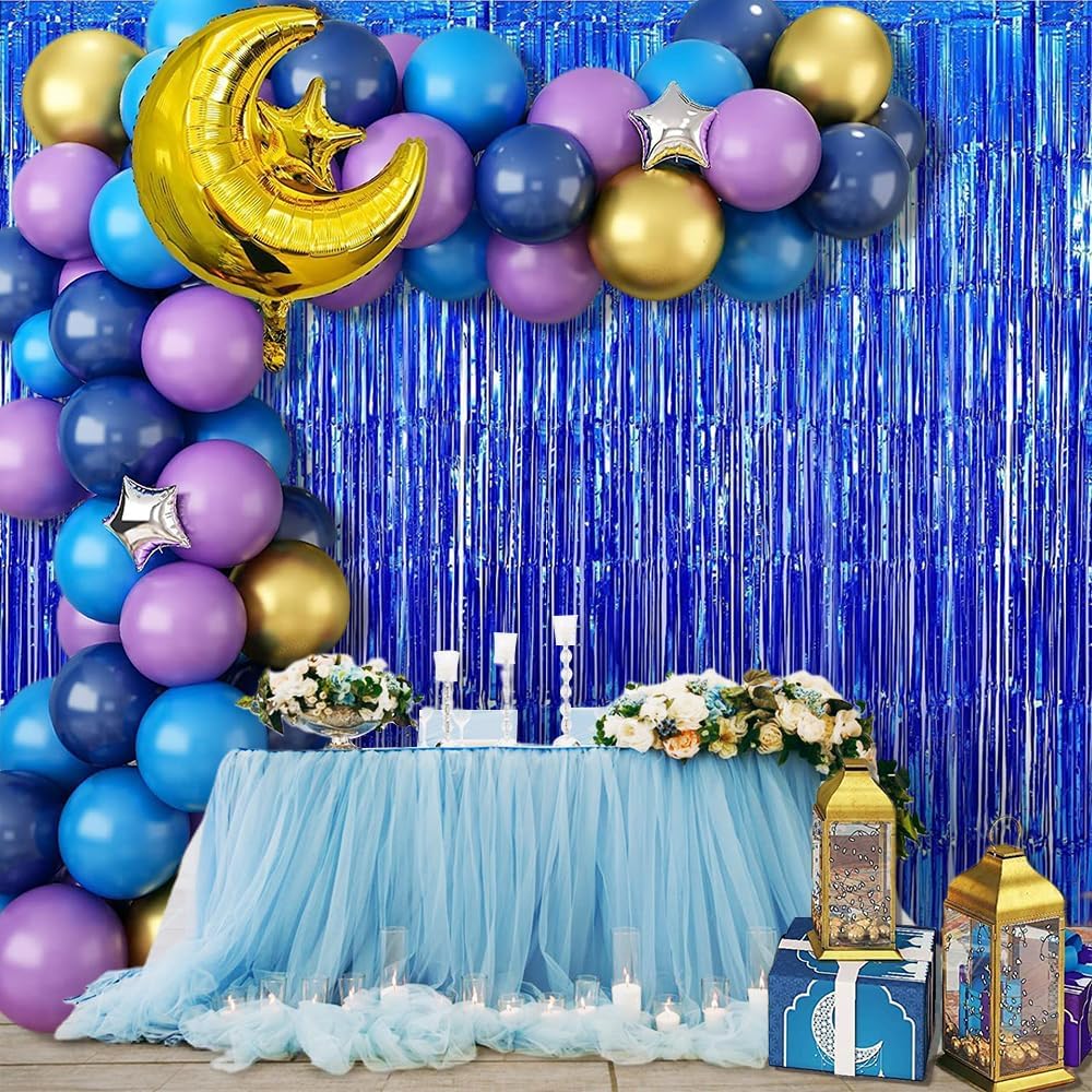“Birthday setup with balloons and blue foil curtain”