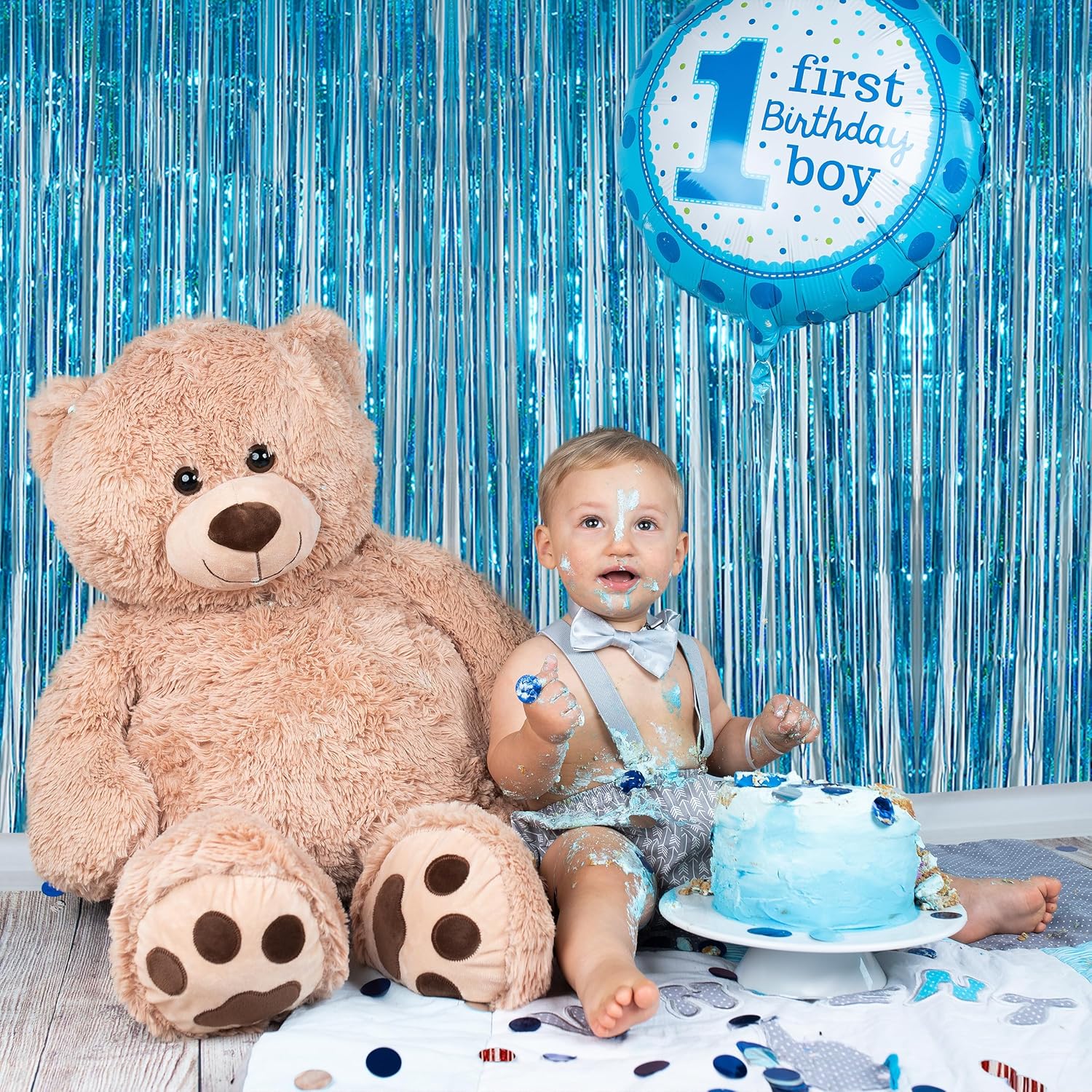 “Baby shower photo setup with light blue foil curtain”