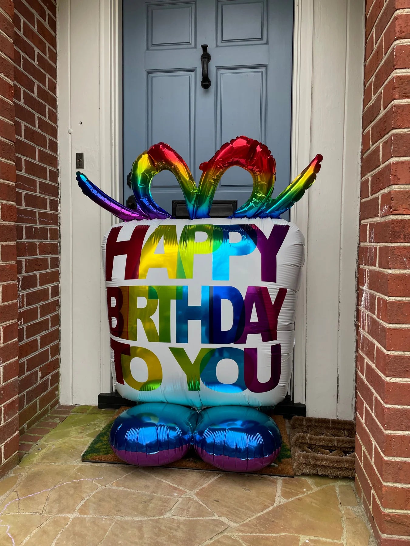 "Oversized birthday present balloon by Anagram in party setting"