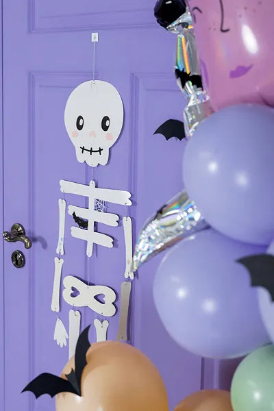 "Hanging pastel skeleton with twine and balloons"