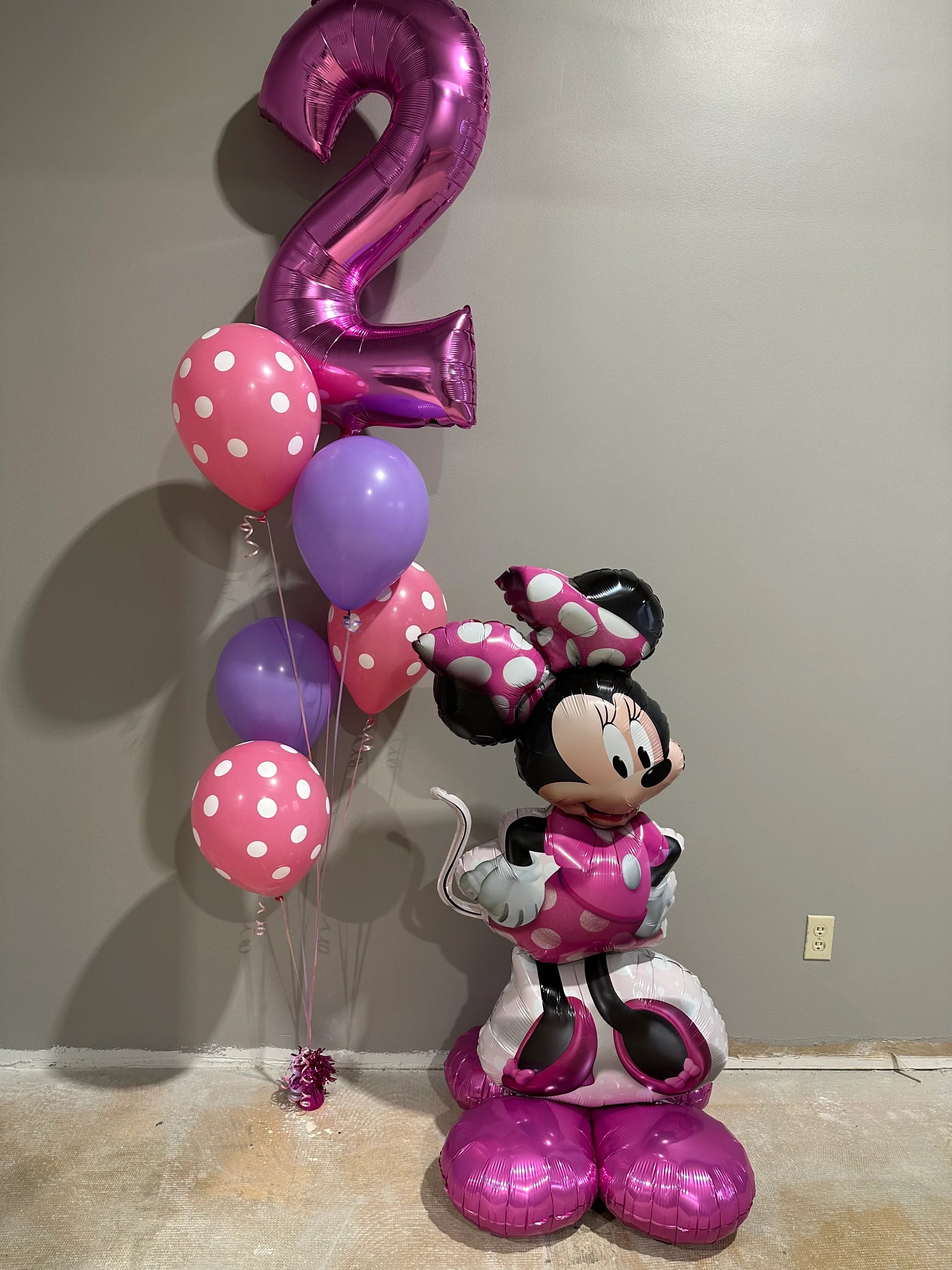 Side view of giant Minnie Mouse foil balloon by Anagram, standing with self-supporting base