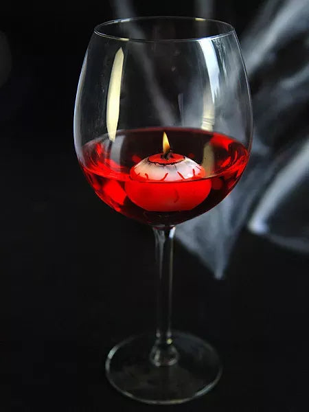 “Eyeball candles floating in water with glowing effect”