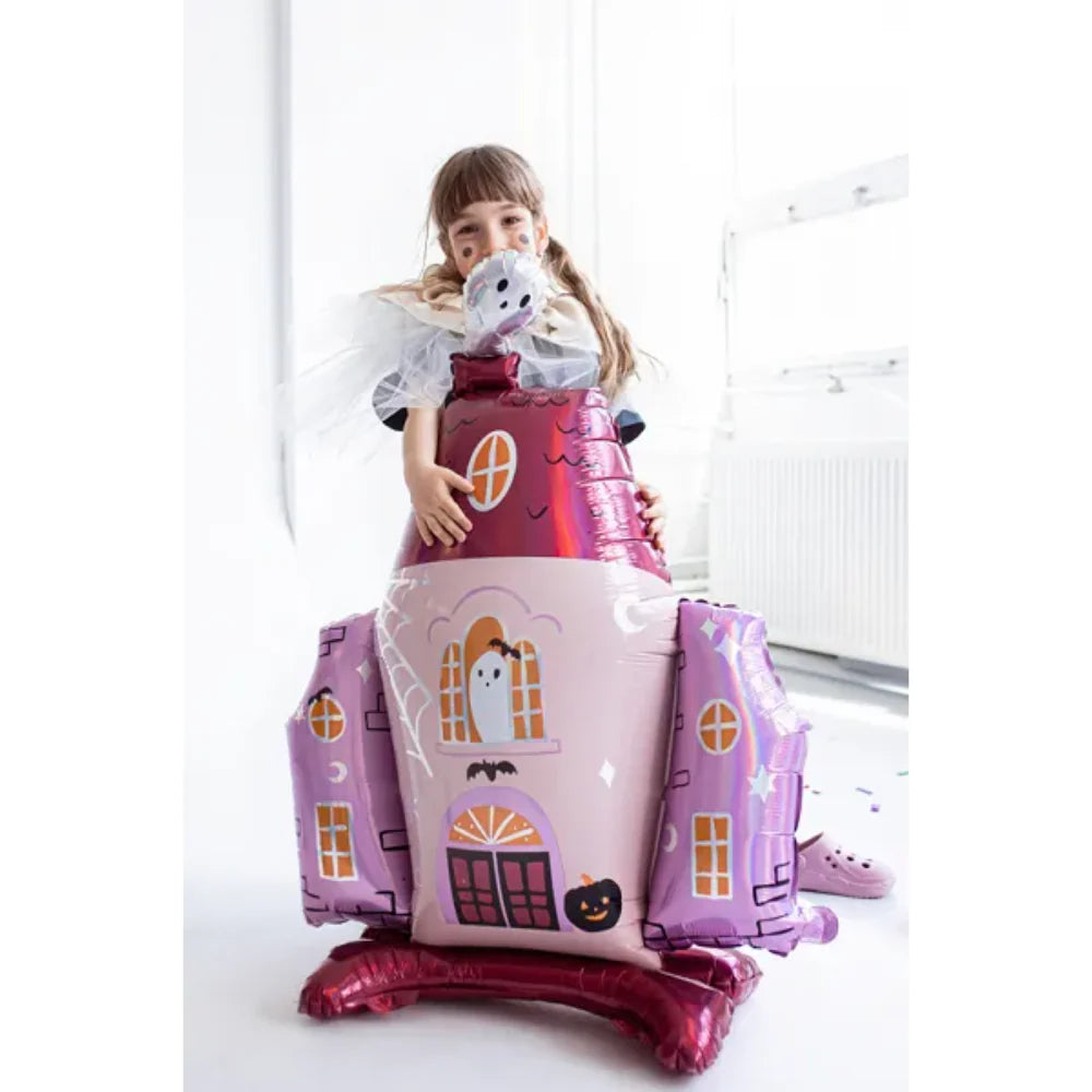 "Child with large haunted house Halloween balloon"