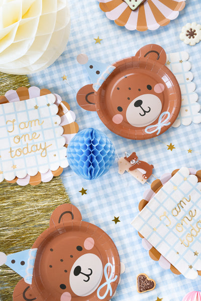 Party table set with “I Am One Today” napkins and teddy bear decorations