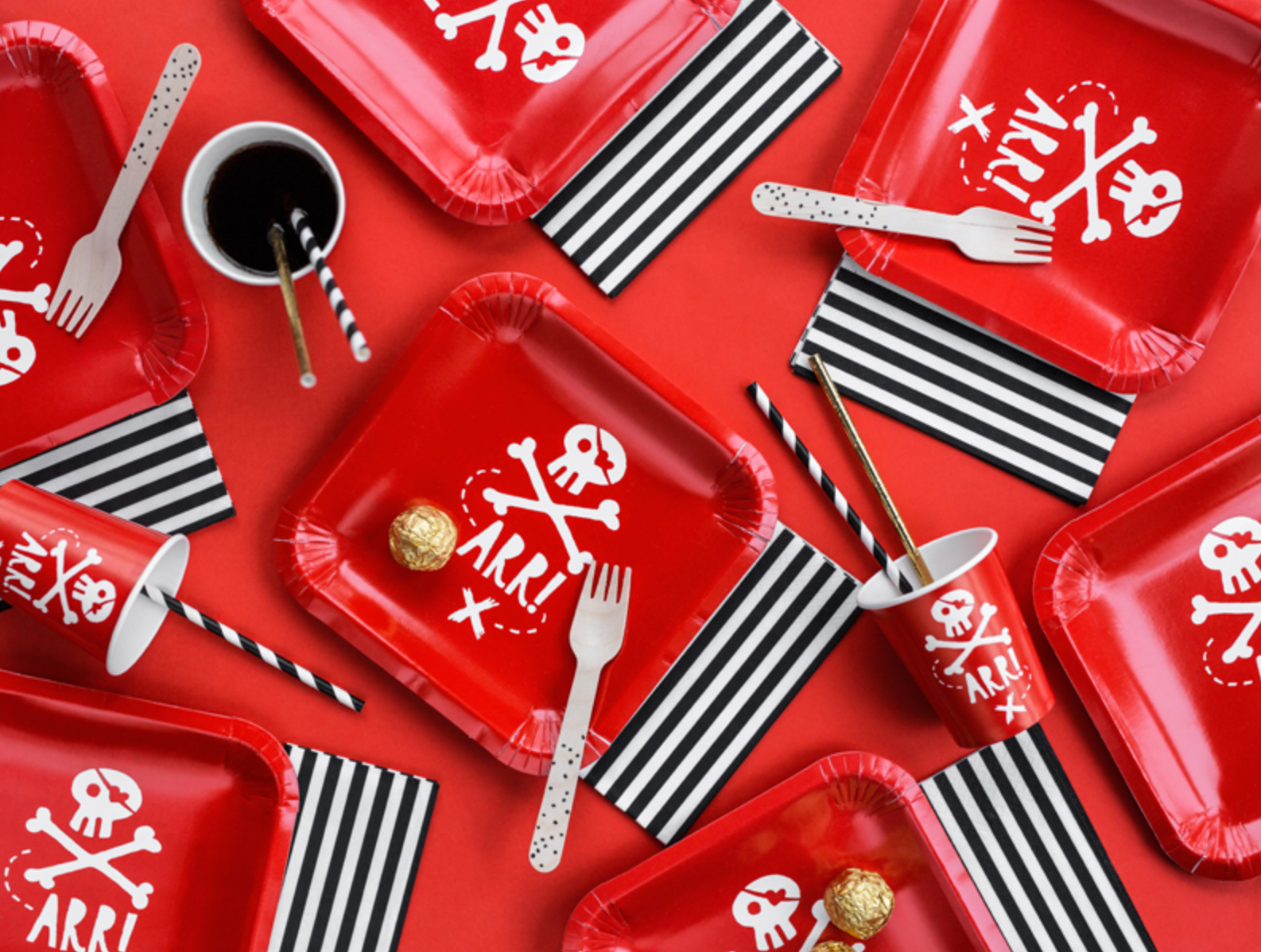 “Pirate-themed tableware set with red pirate cups and plates”