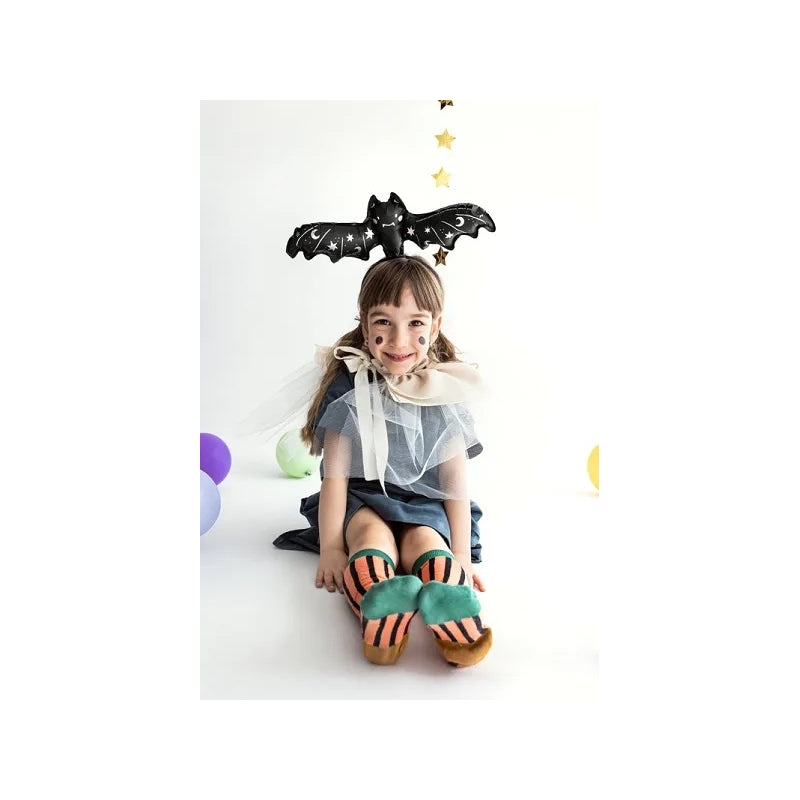“Child wearing bat foil balloon for Halloween costume”