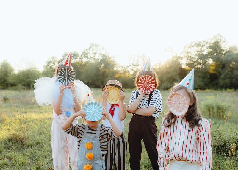 Child enjoying outdoor party wearing a pompom hat