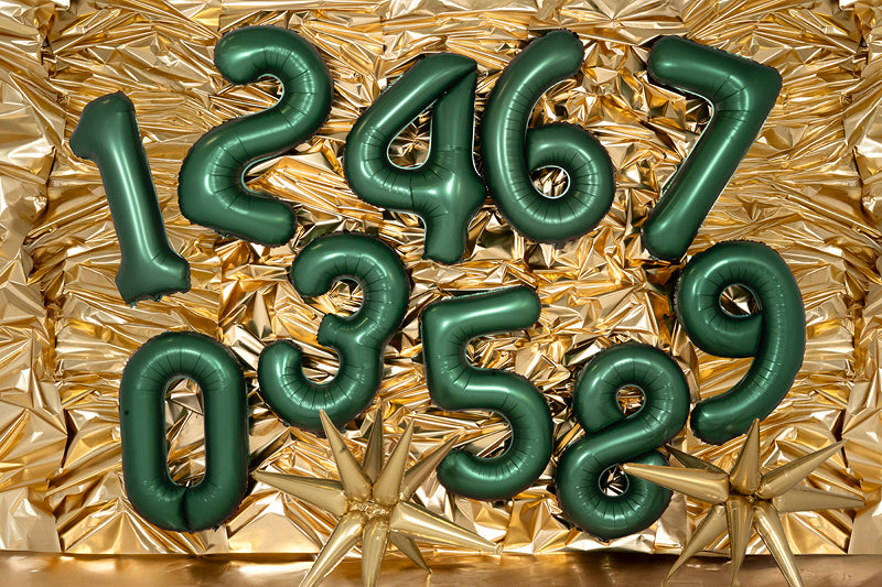 Full set of bottle green number balloons 0–9 on gold backdrop