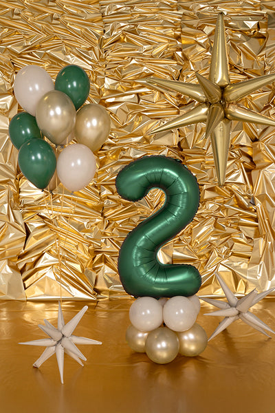Number 2 balloon styled with gold and white party decorations