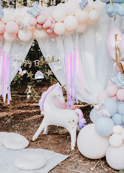 Standing foil unicorn balloon with golden horn and pastel mane for parties