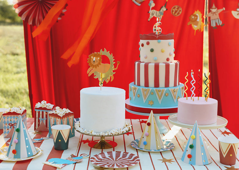 Birthday table setup with circus snack boxes and cake
