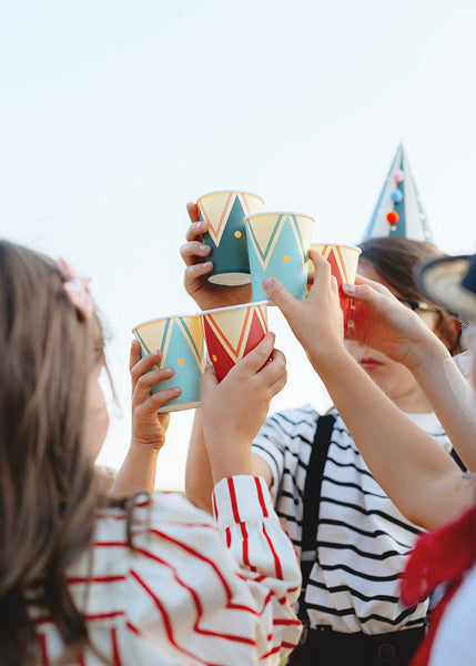 Colorful circus-themed party cups with drum design in red, teal, and navy