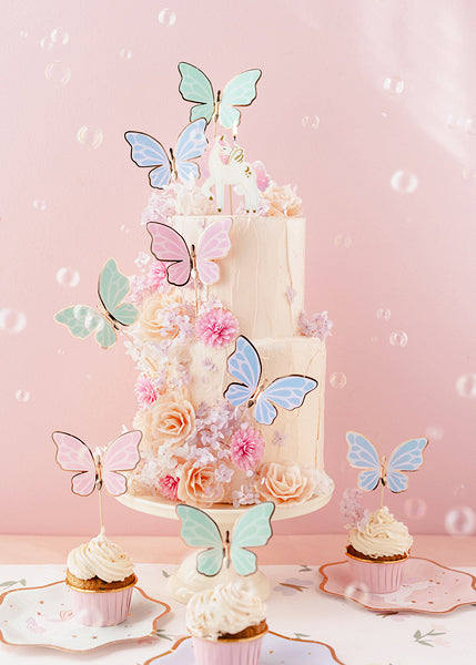 Pastel butterfly cake toppers with gold accents for birthdays and fairy-themed parties