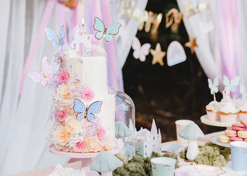 Pastel butterfly cake toppers with gold accents for birthdays and fairy-themed parties
