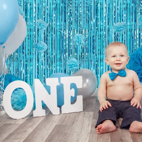 “Birthday backdrop with light blue foil curtain”