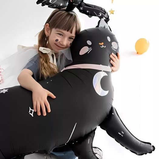 Girl hugging large cat-shaped foil balloon