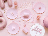 Light pink plastic frill plate with scalloped edge for birthday or baby shower