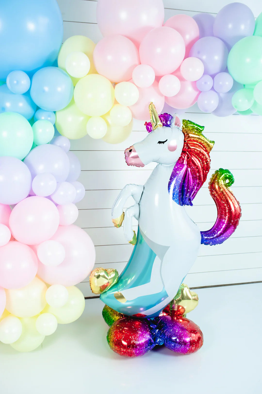 Unicorn balloon decoration with rainbow backdrop, party display for kids