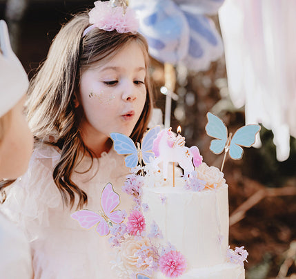 Pastel butterfly cake toppers with gold accents for birthdays and fairy-themed parties