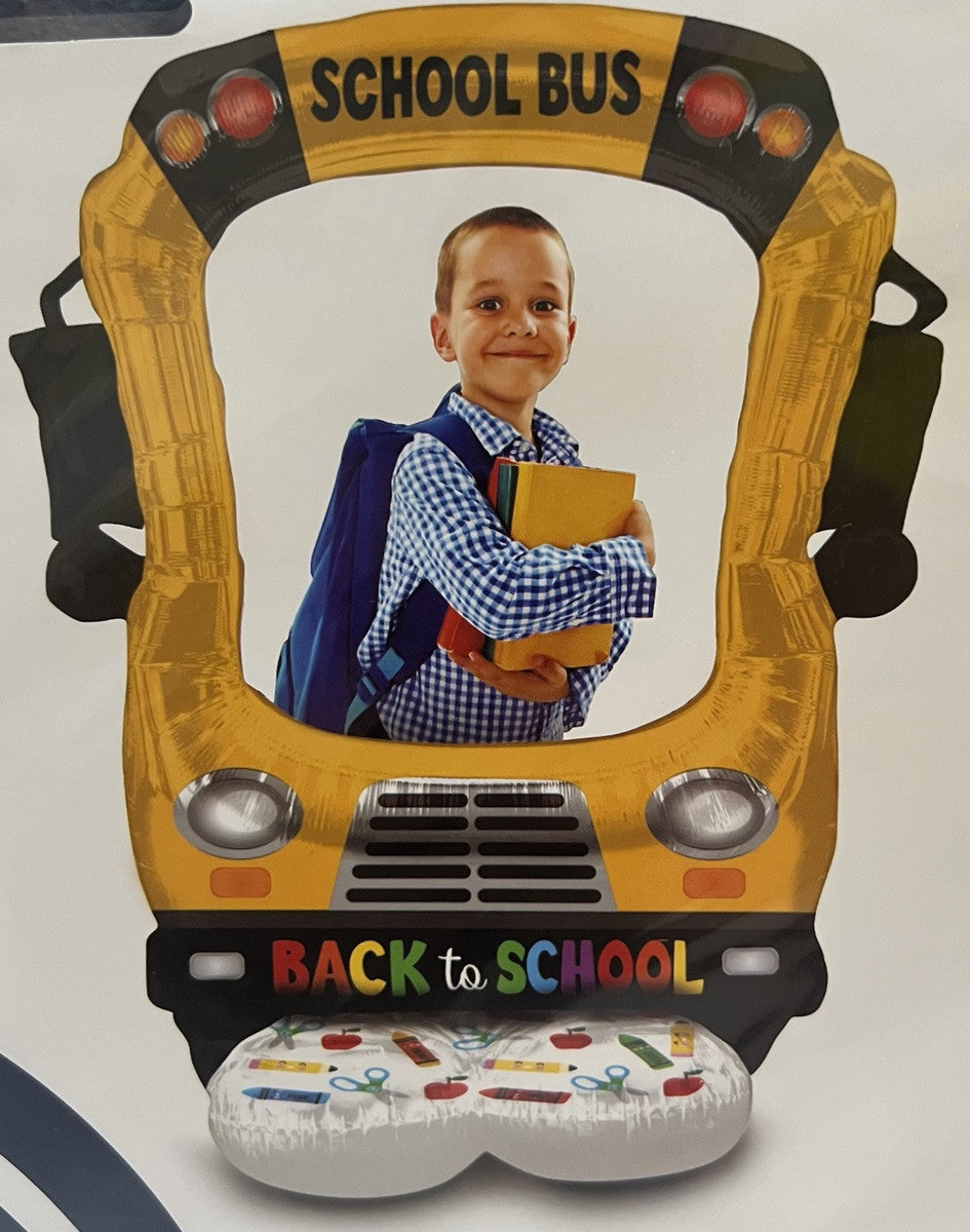Boy standing inside Airloonz school bus balloon – first day of school photo idea