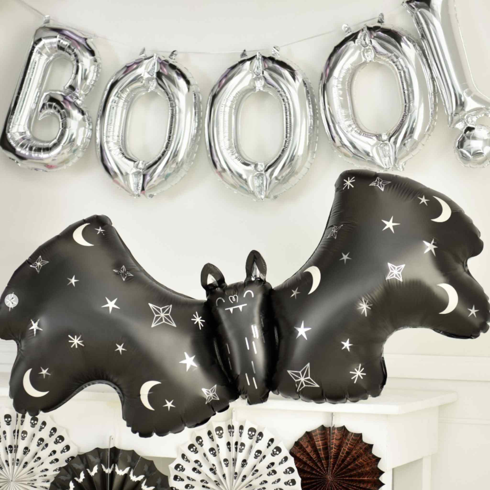 Halloween party backdrop with satin bat and silver letter balloons