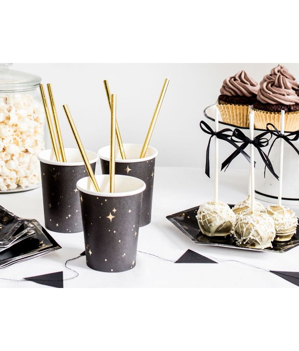 et of black and gold disposable paper cups on a table